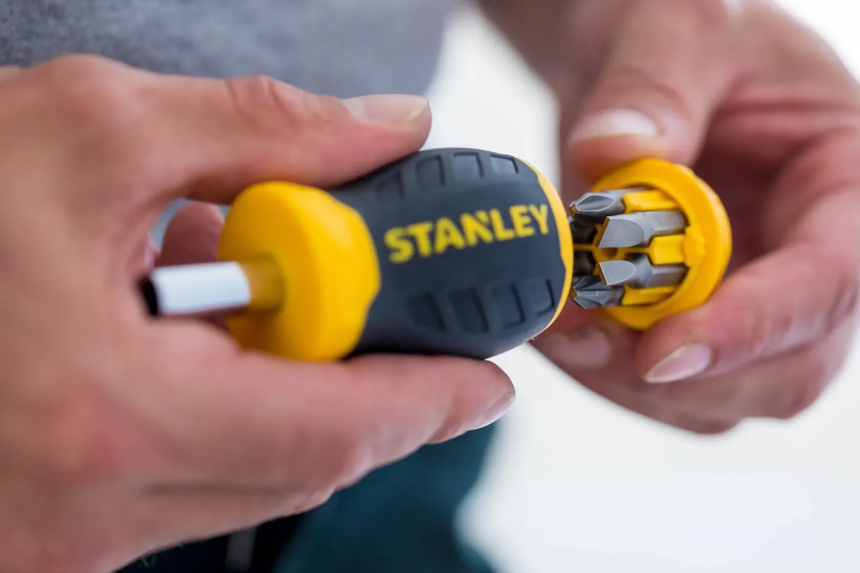STANLEY 0-66-357 multi-bit screwdriver with yellow and black handle, close-up, showing bit storage in cap.
