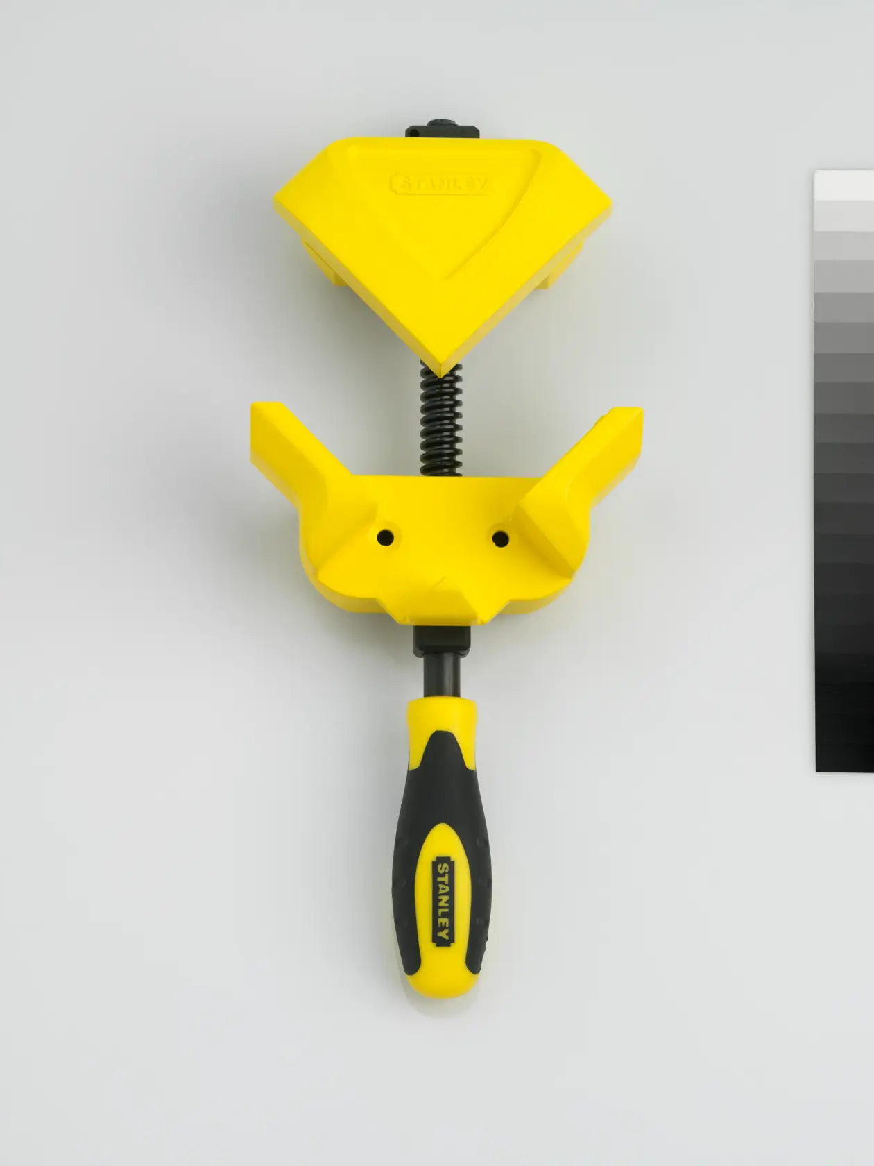 STANLEY 0-83-122 corner clamp tool, yellow and black, flat lay angle.