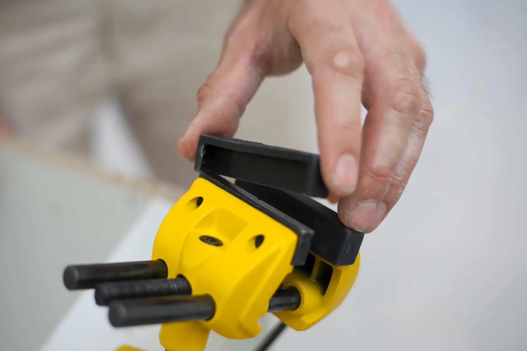 STANLEY 1-83-069 photography of yellow clamp with black jaws being adjusted by hand.
