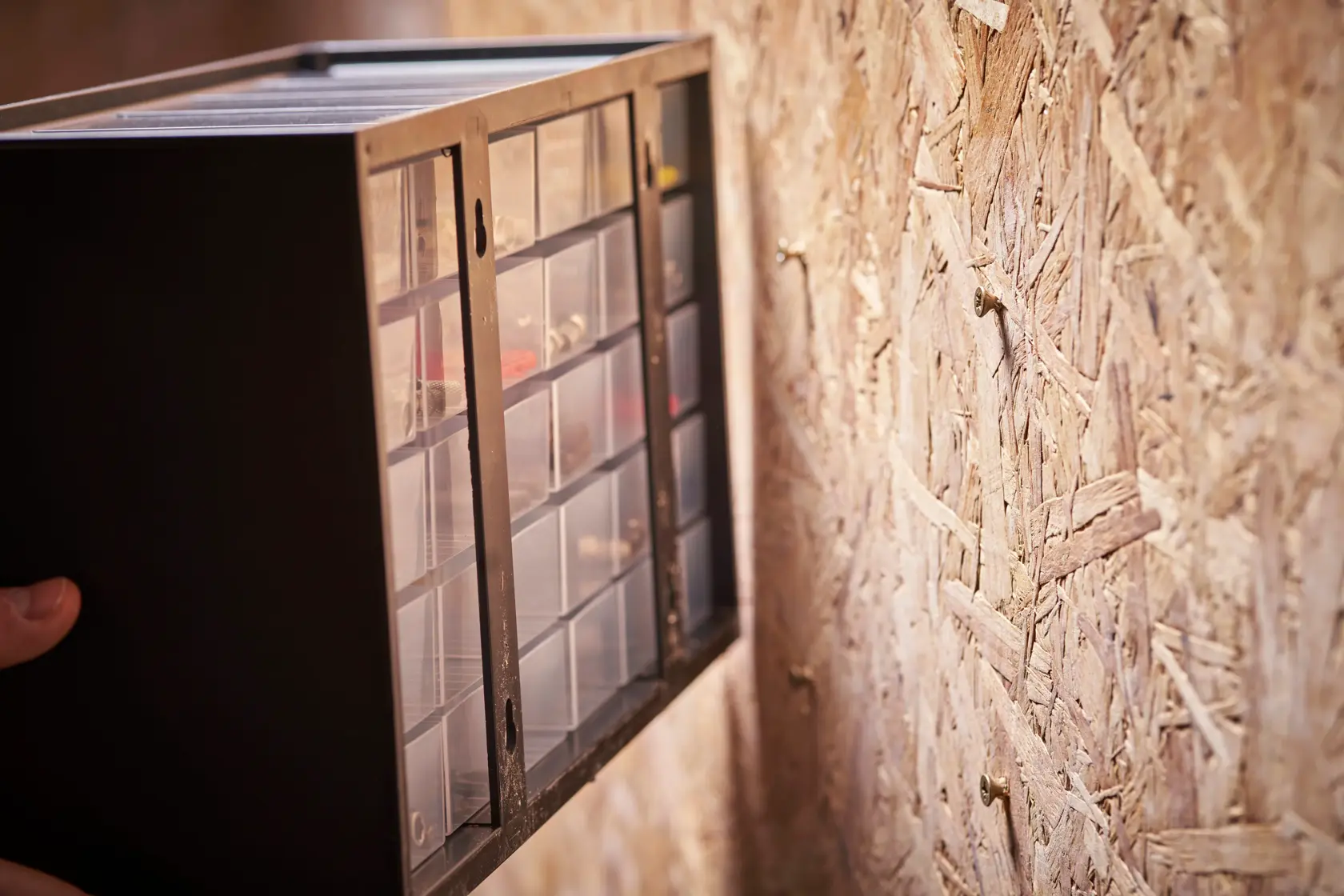 STANLEY 1-93-980 wall-mounted small parts organizer with clear drawers, angled side view.