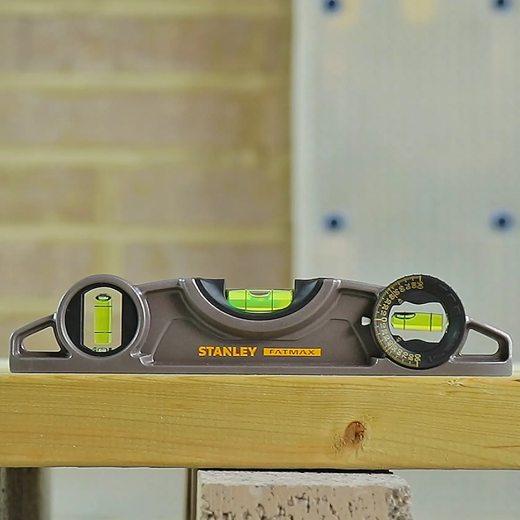 STANLEY 43-609I torpedo level with three vials on wooden beam, product side view.