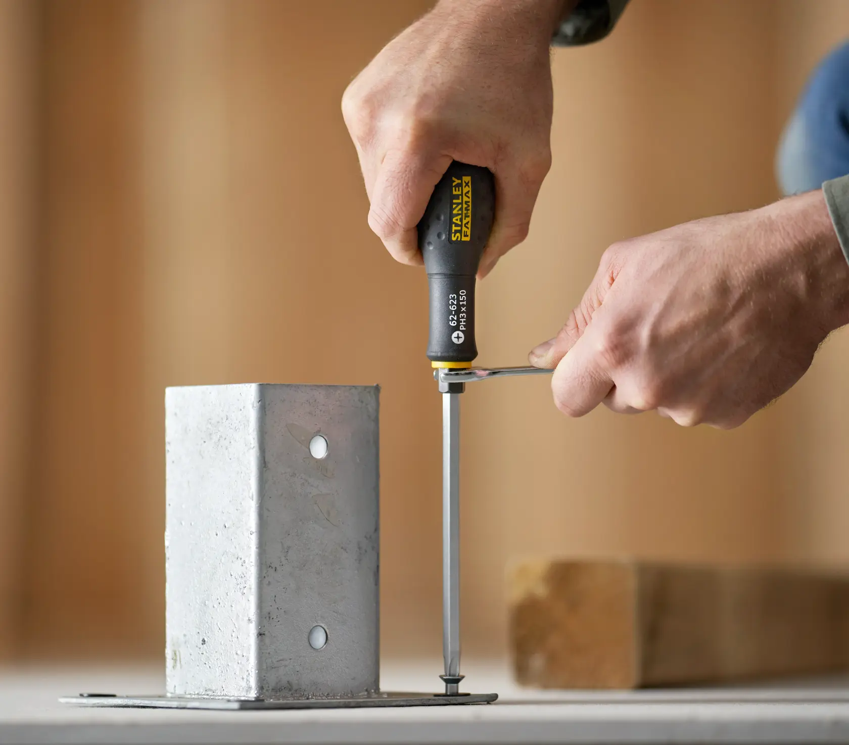 Photo of STANLEY FMHT0-62623 screwdriver being used to tighten a screw in a metal bracket.