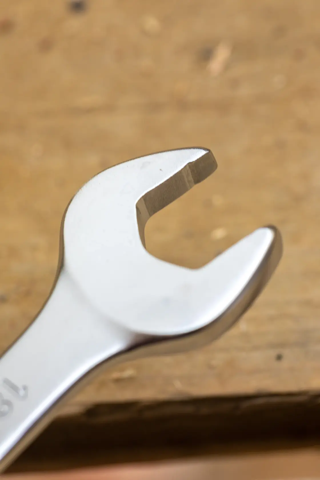 STANLEY FMMT13084-0 open-end wrench closeup on wood background, silver finish, hand tool.