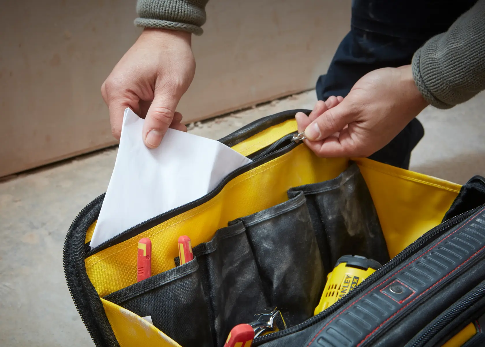 Photo of STANLEY FMST1-73607 tool bag with yellow interior, showing pockets and storing tools and documents.