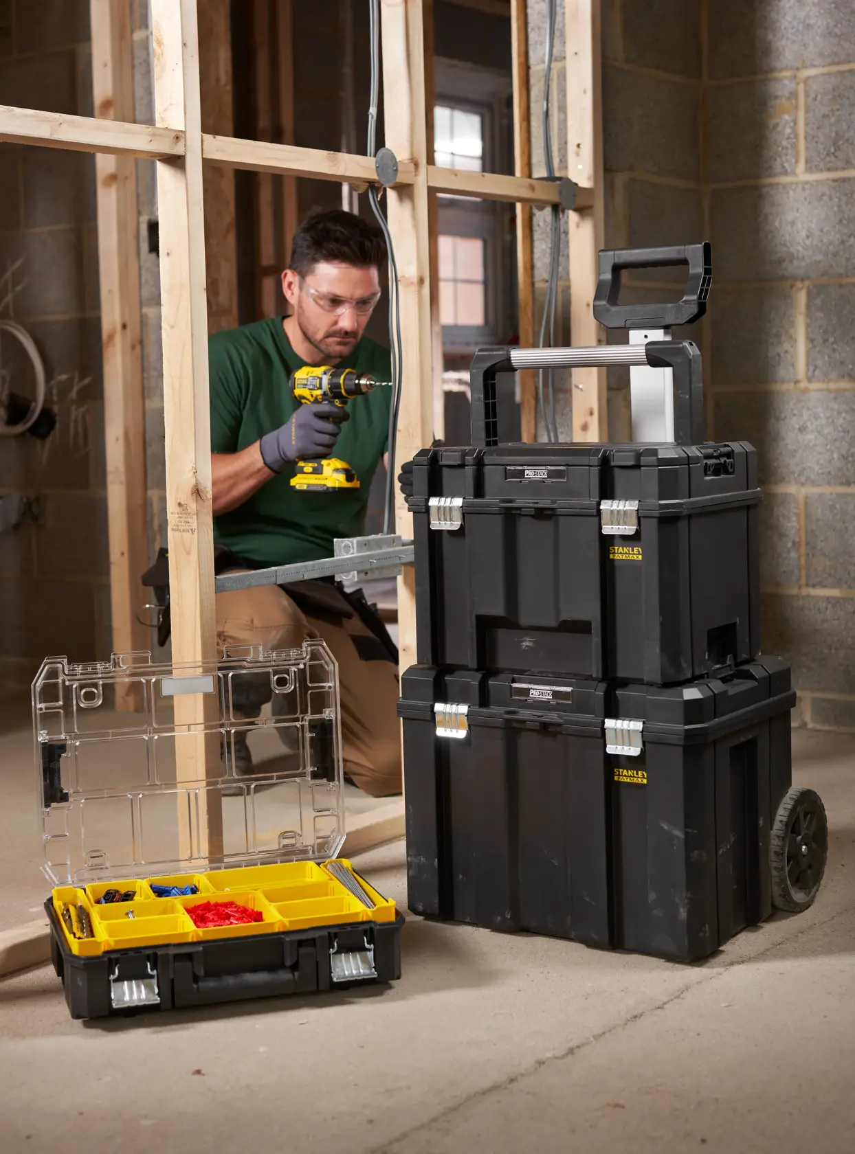 STANLEY FMST1-75753 stackable toolbox set and organizer box in jobsite, black with yellow compartments.