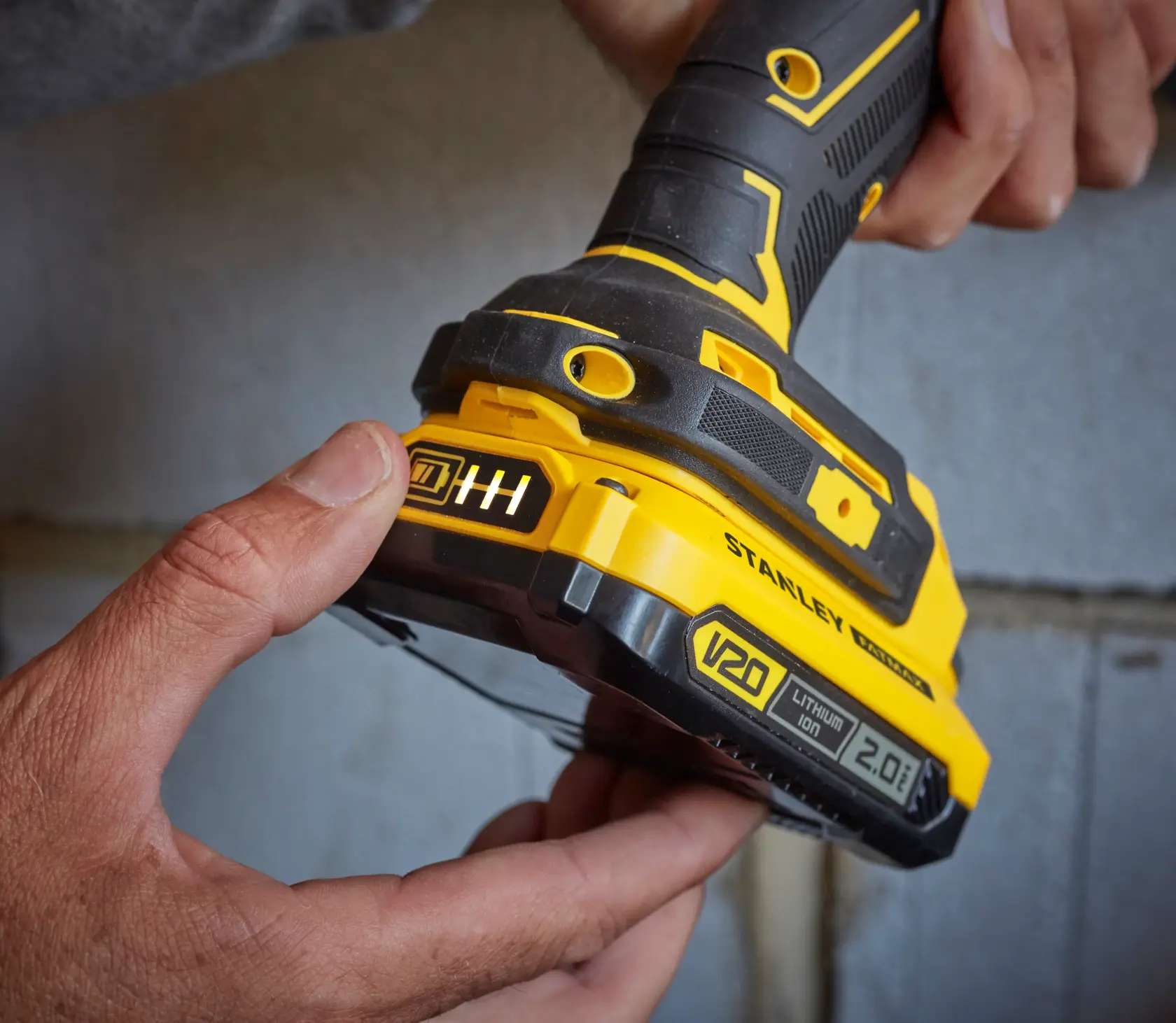 Photo of STANLEY SB202 cordless power tool with V20 2.0Ah lithium-ion battery, close-up angle.