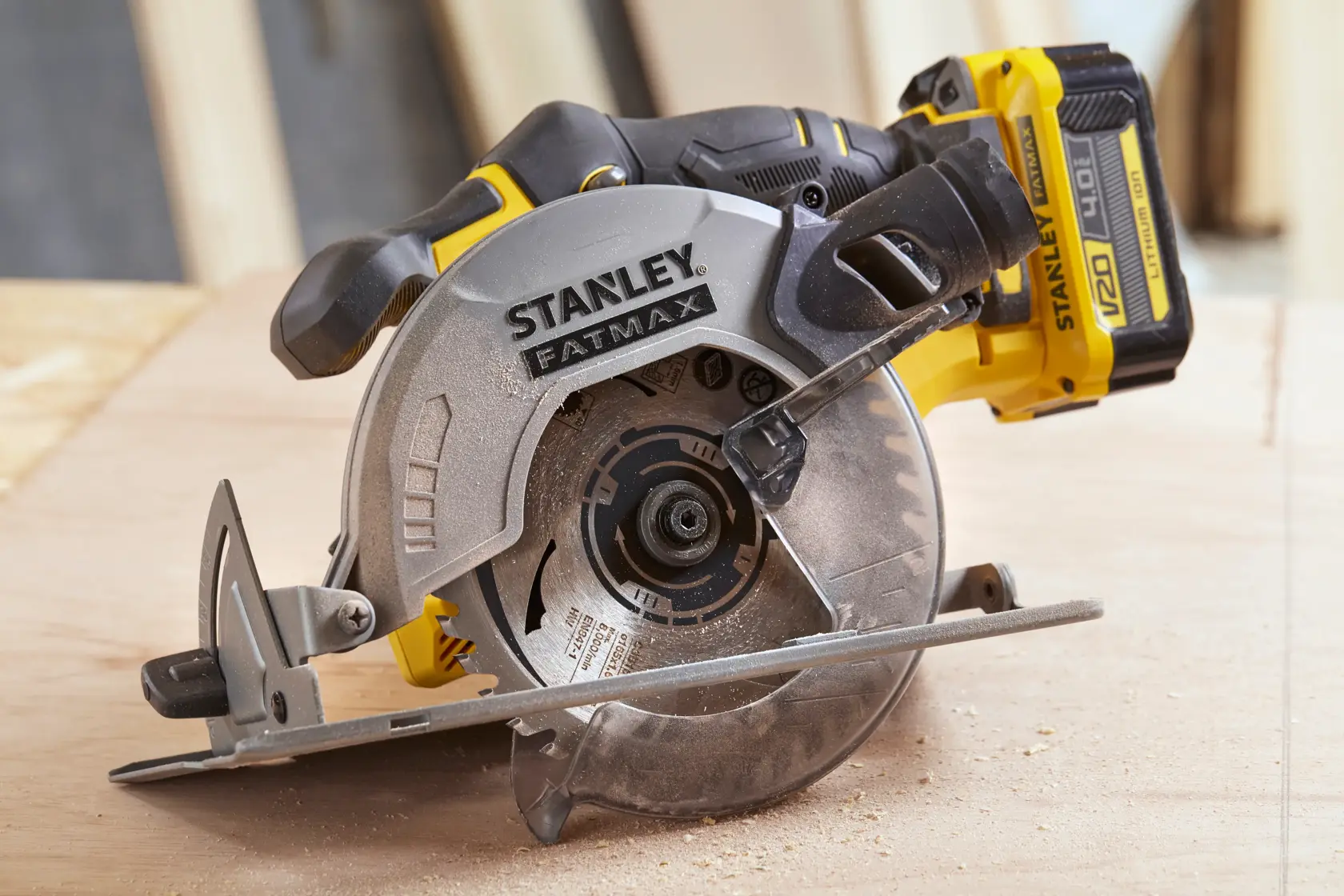 STANLEY SCC500 circular saw with yellow and black body shown cutting wood, side angle view.