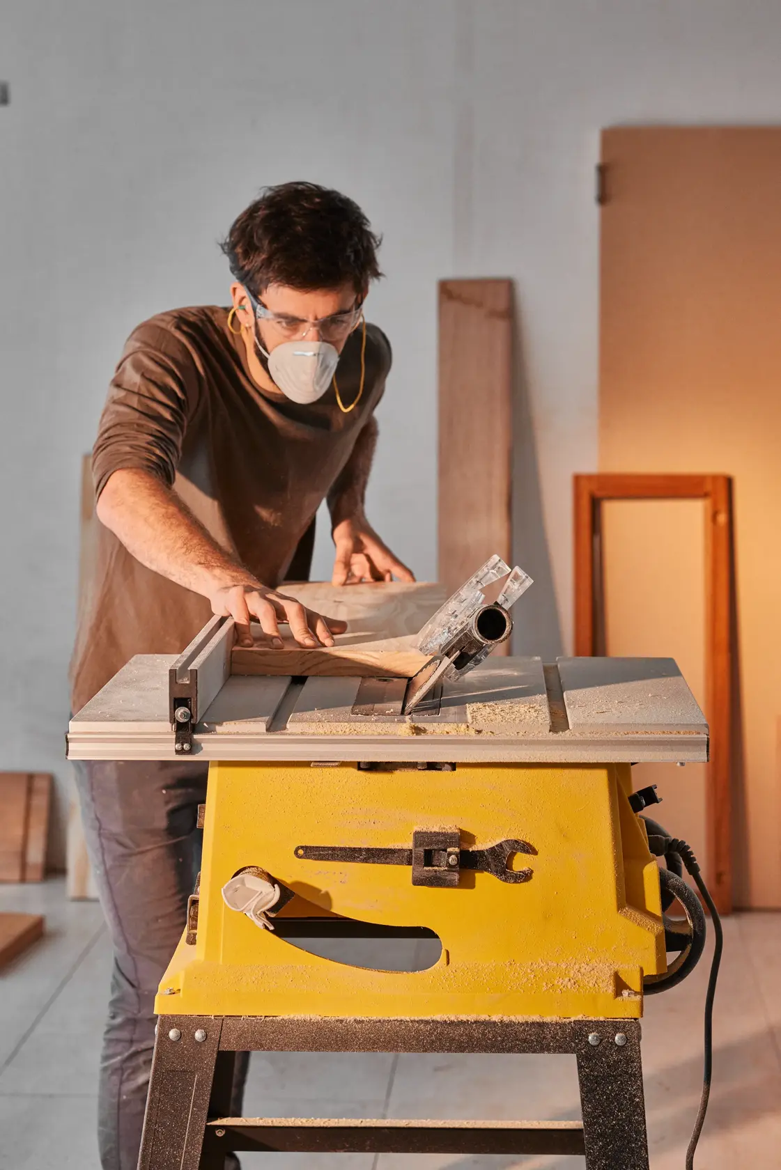 Photo of STANLEY SST2001-B2 table saw in use, yellow base, wood being cut in a workshop setting.