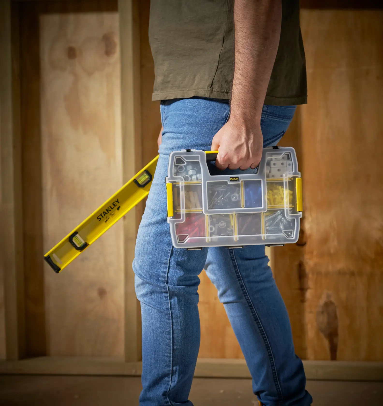 STANLEY STST1-70720 organizer box with yellow accents held by person, next to STANLEY spirit level.