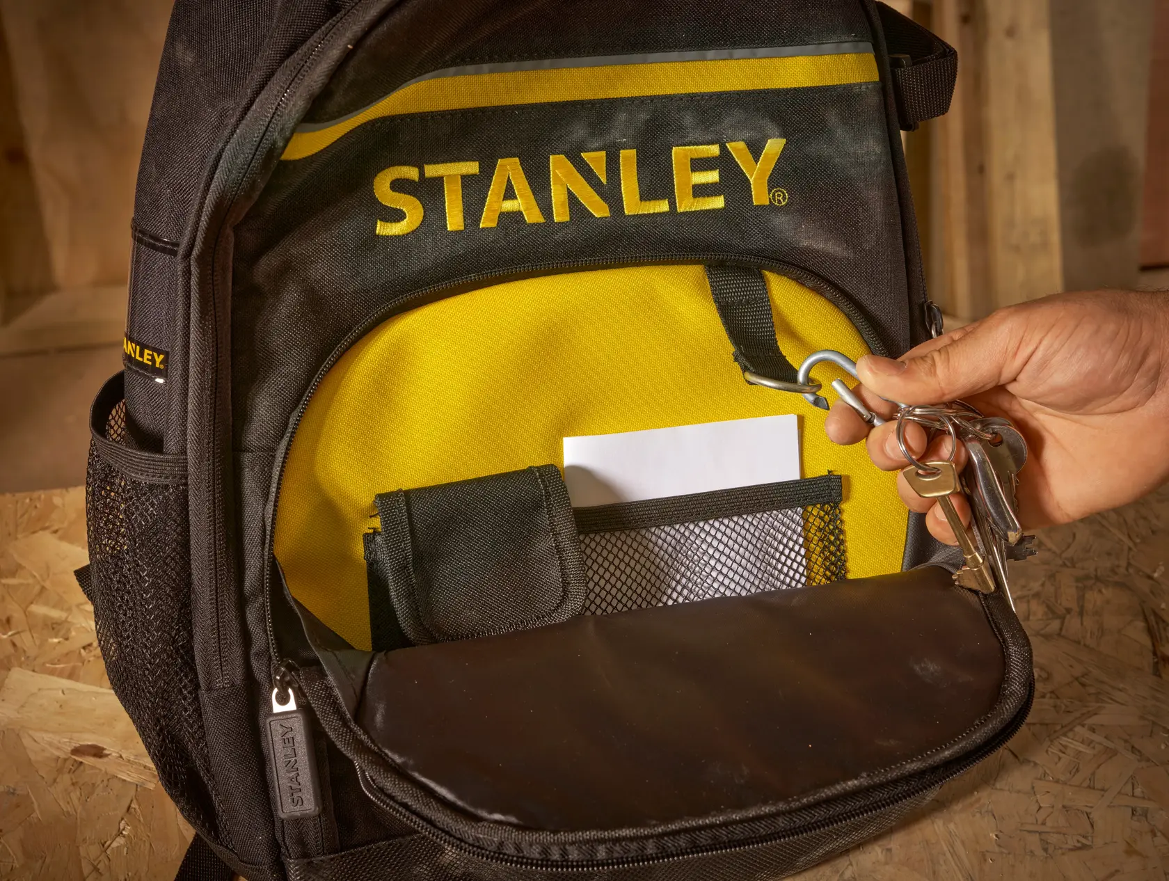 STANLEY STST1-72335 backpack front pocket with key holder, mesh pouch and yellow lining, close-up photo
