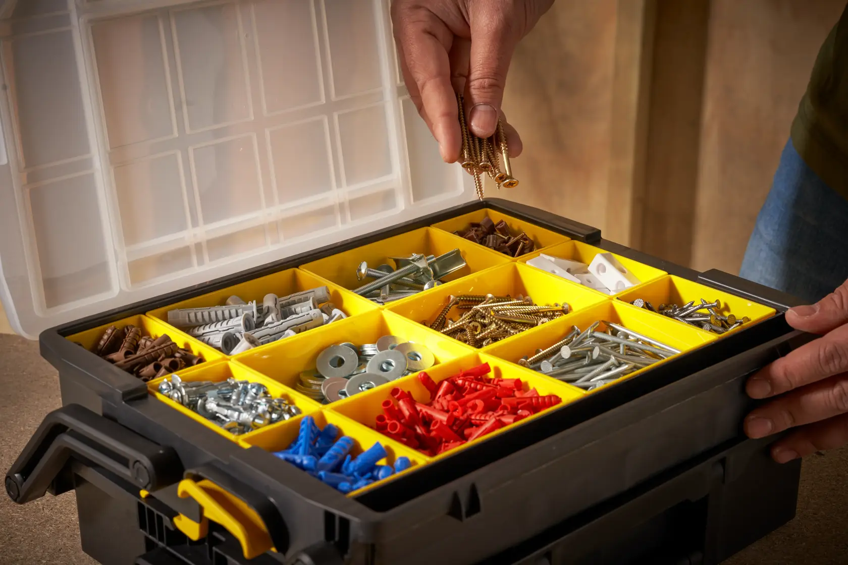 STANLEY STST1-75540 organizer box with yellow compartments holding assorted fasteners, top angle photo.