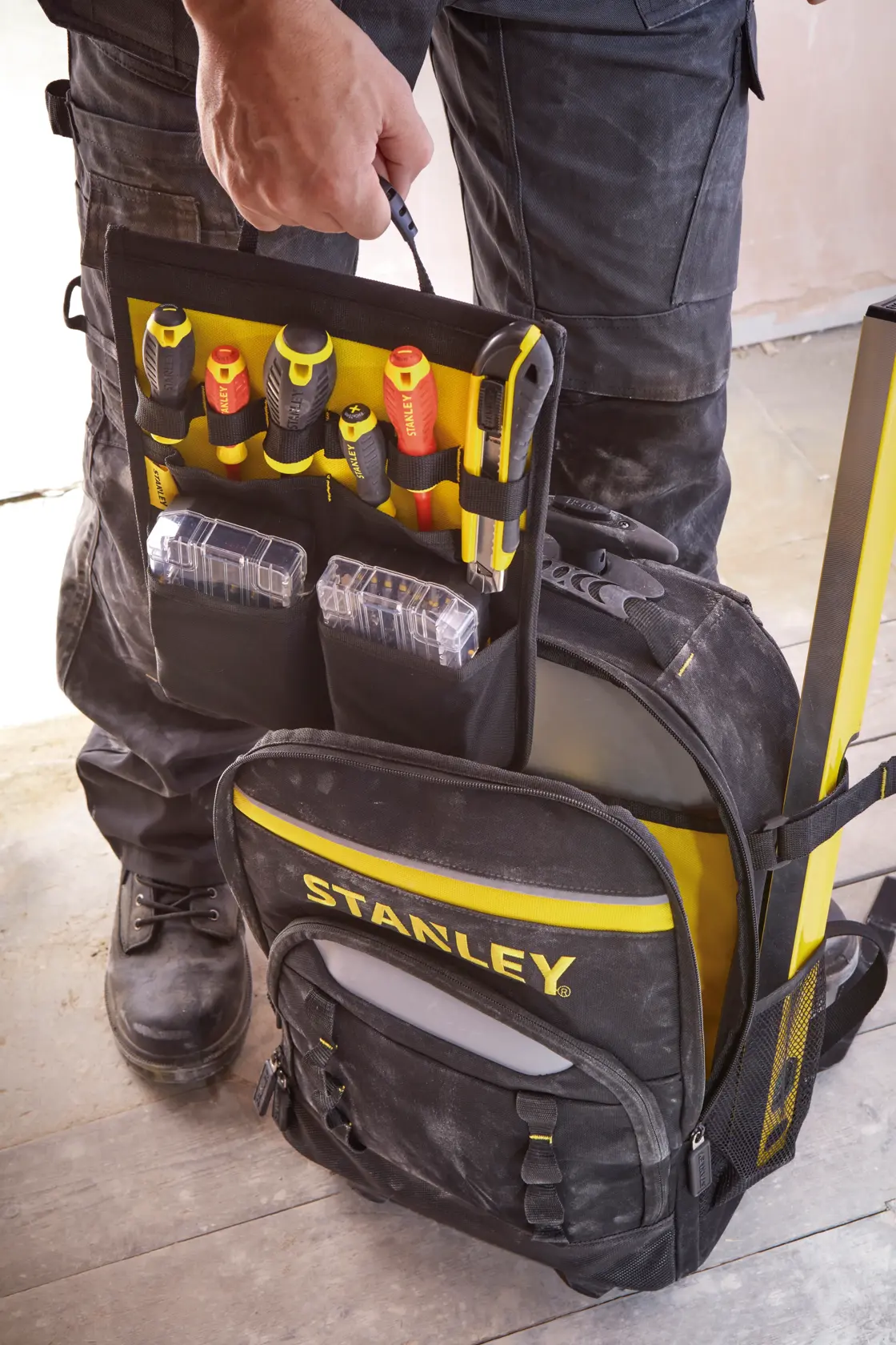 STANLEY STST83307-1 black and yellow tool backpack open, showing organized tools and boxes, front angle.