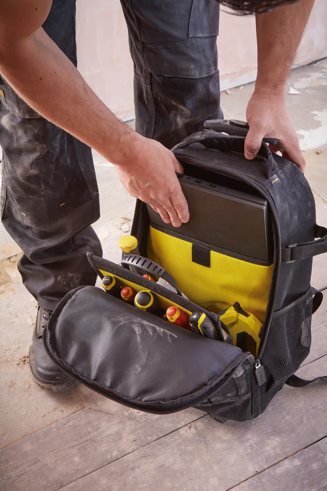 STANLEY STST83307-1 tool backpack with yellow interior, open front shows tools and tablet storage.