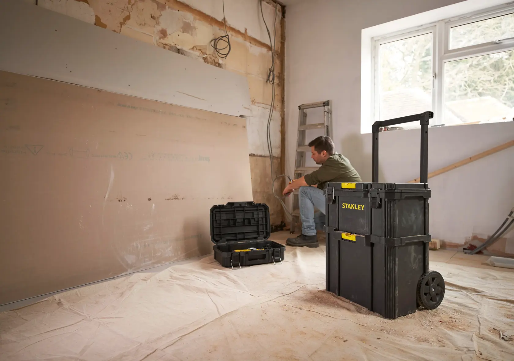 Stanley STST83319-1 rolling toolbox in a renovation setting with open tool case, photo of product in use.